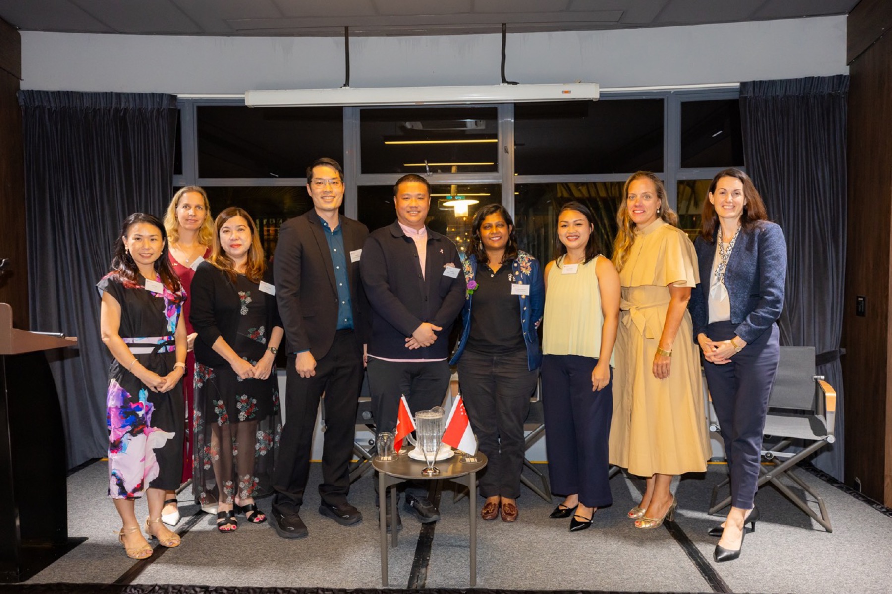 Speakers and hosts standing together at the forum