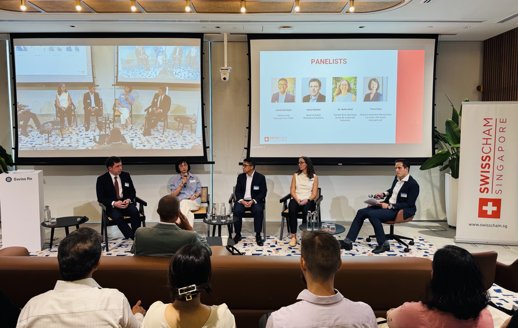 Five panellists on stage in front of an audience