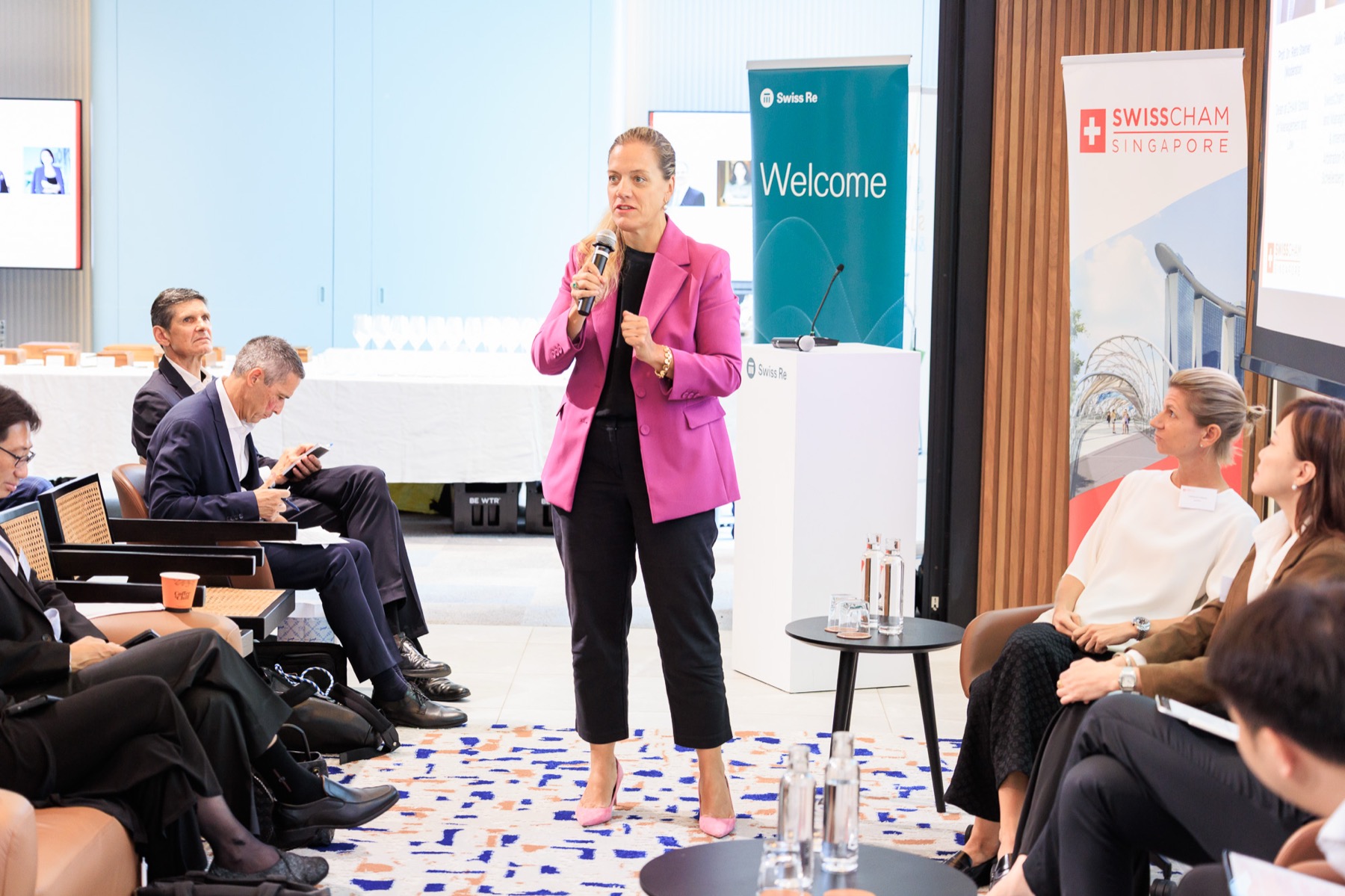 A speaker addressing the room with a microphone