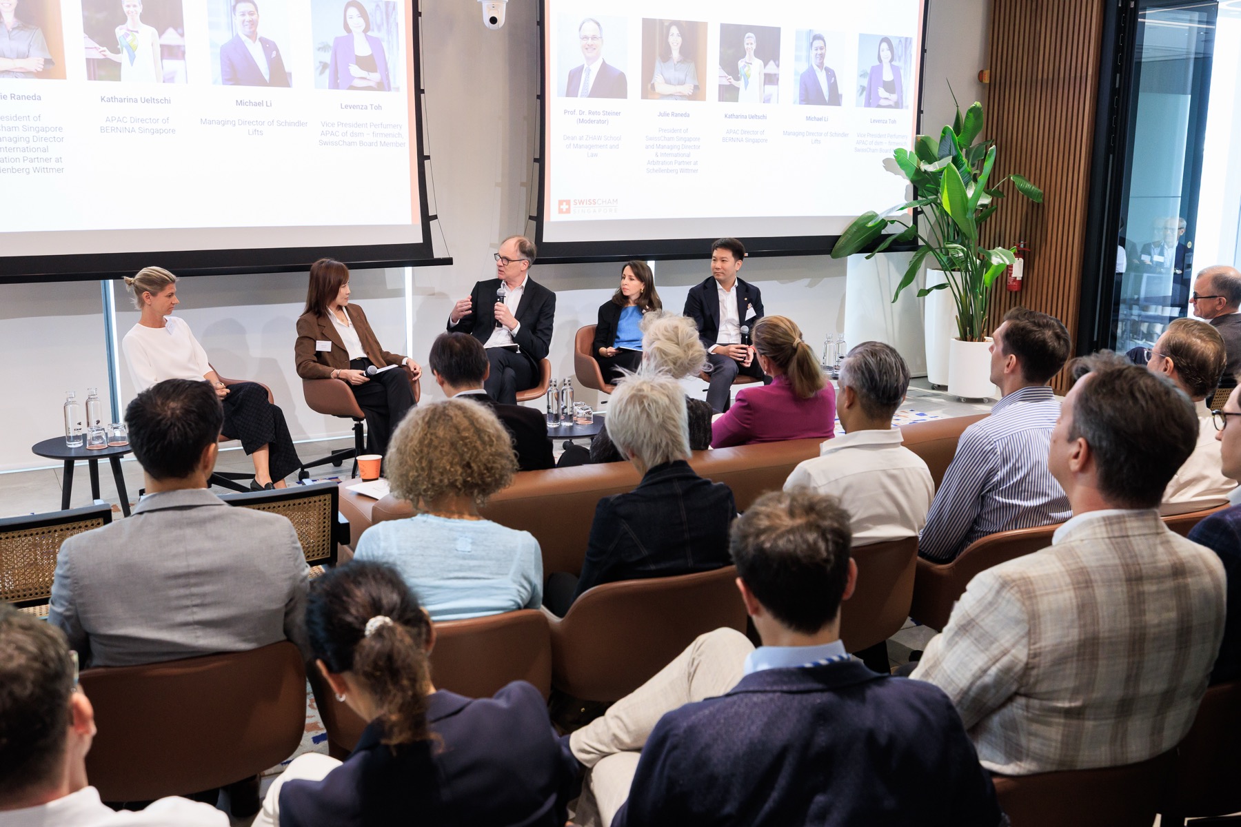 A panel discussion in front of a seated audience